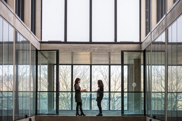 Students in front of a large glass window in the Department of Economics