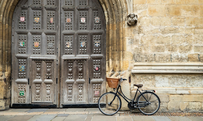 A close up of a bike leant against a doorway in Oxford