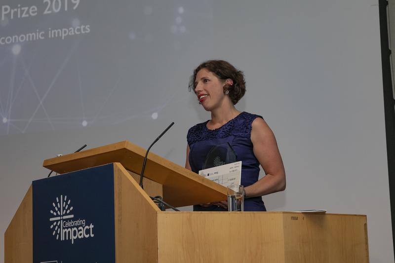 Shona Minson stands at a podium to give a speech at the ESRC impact awards