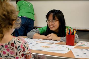 A DPhil researchers interacts with a young girl