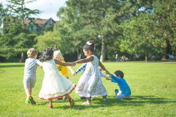Children playing children playing in a green space with trees